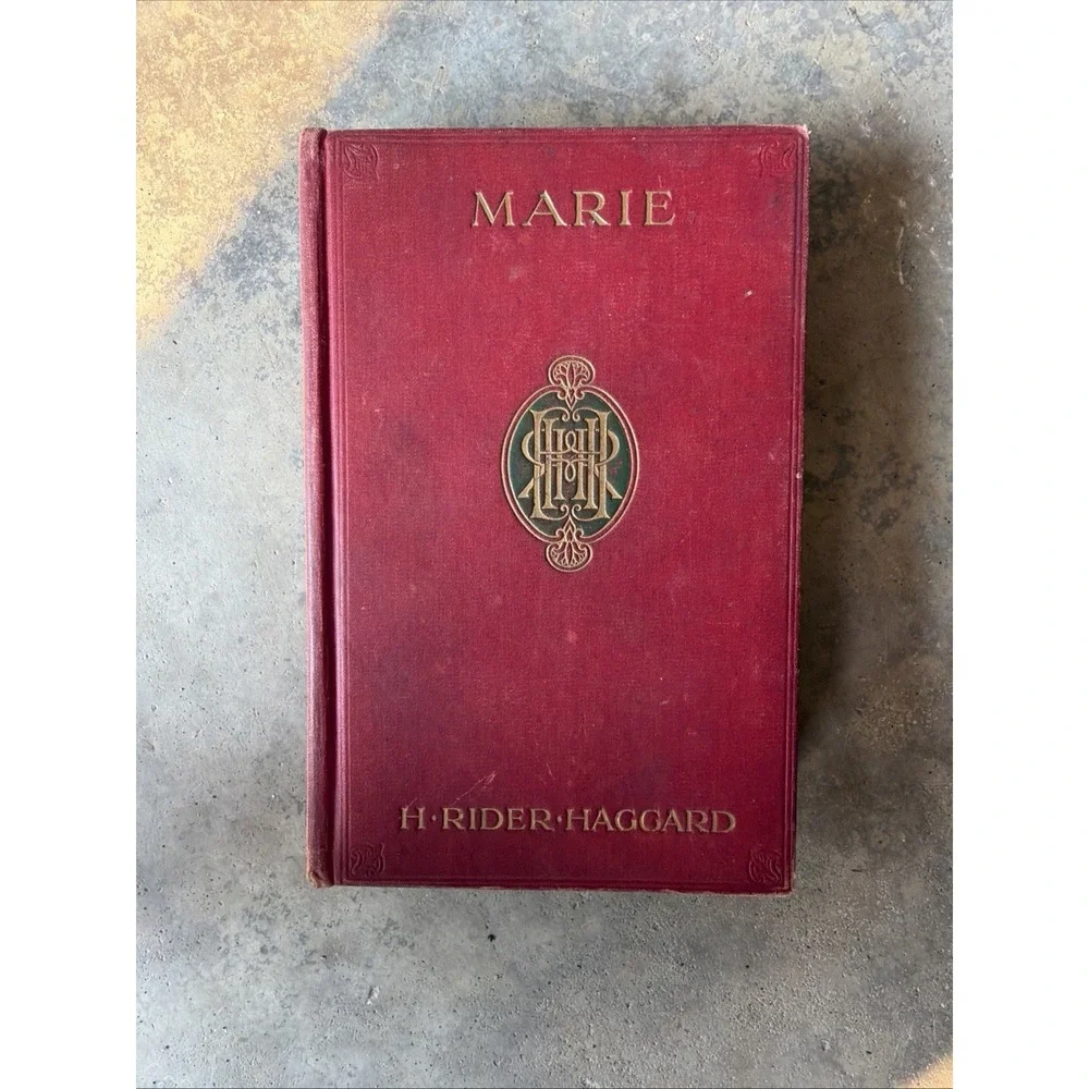 red hardcover book shown is a vintage 1912 edition of Marie by H. Rider Haggard